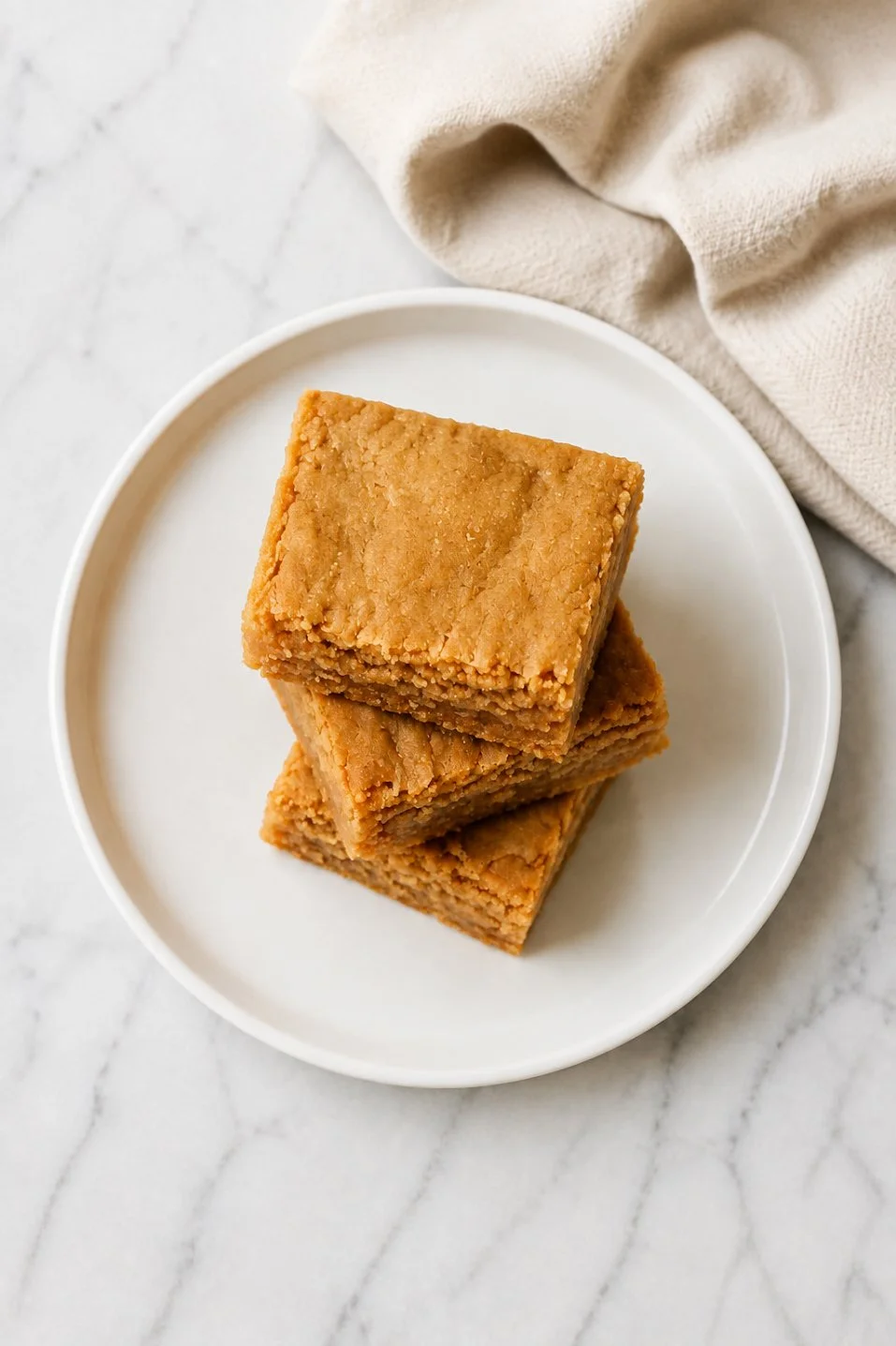 3-ingredient peanut butter blondies on a plate ready to serve