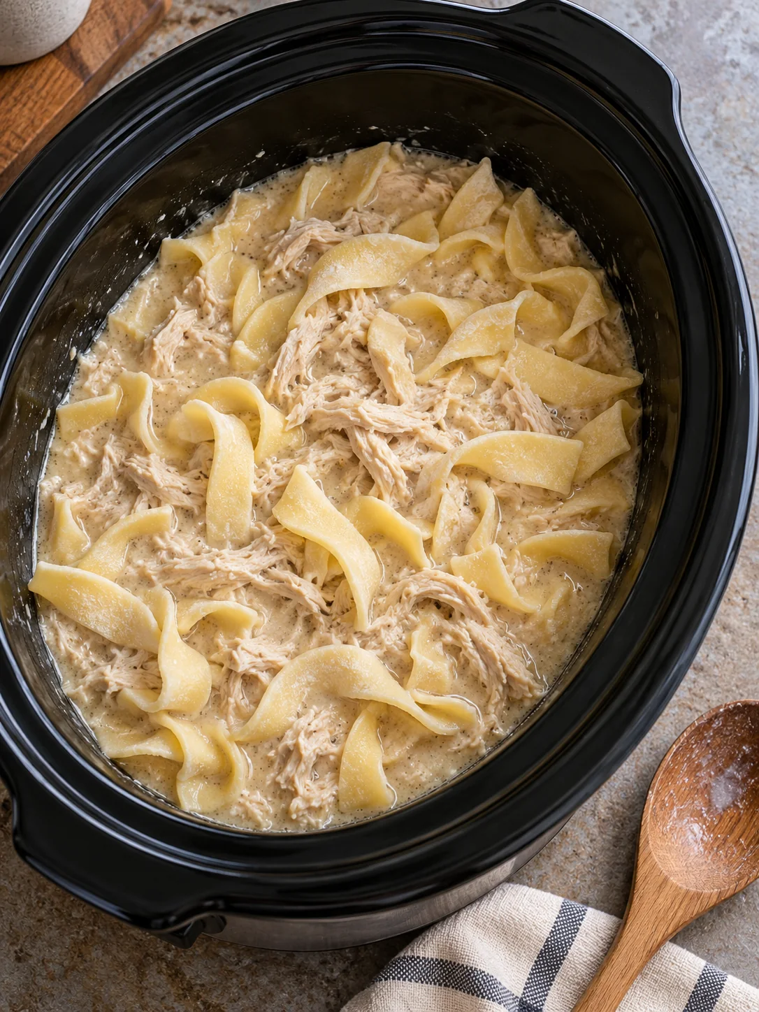 Frozen egg noodles stirred into creamy shredded chicken in the slow cooker