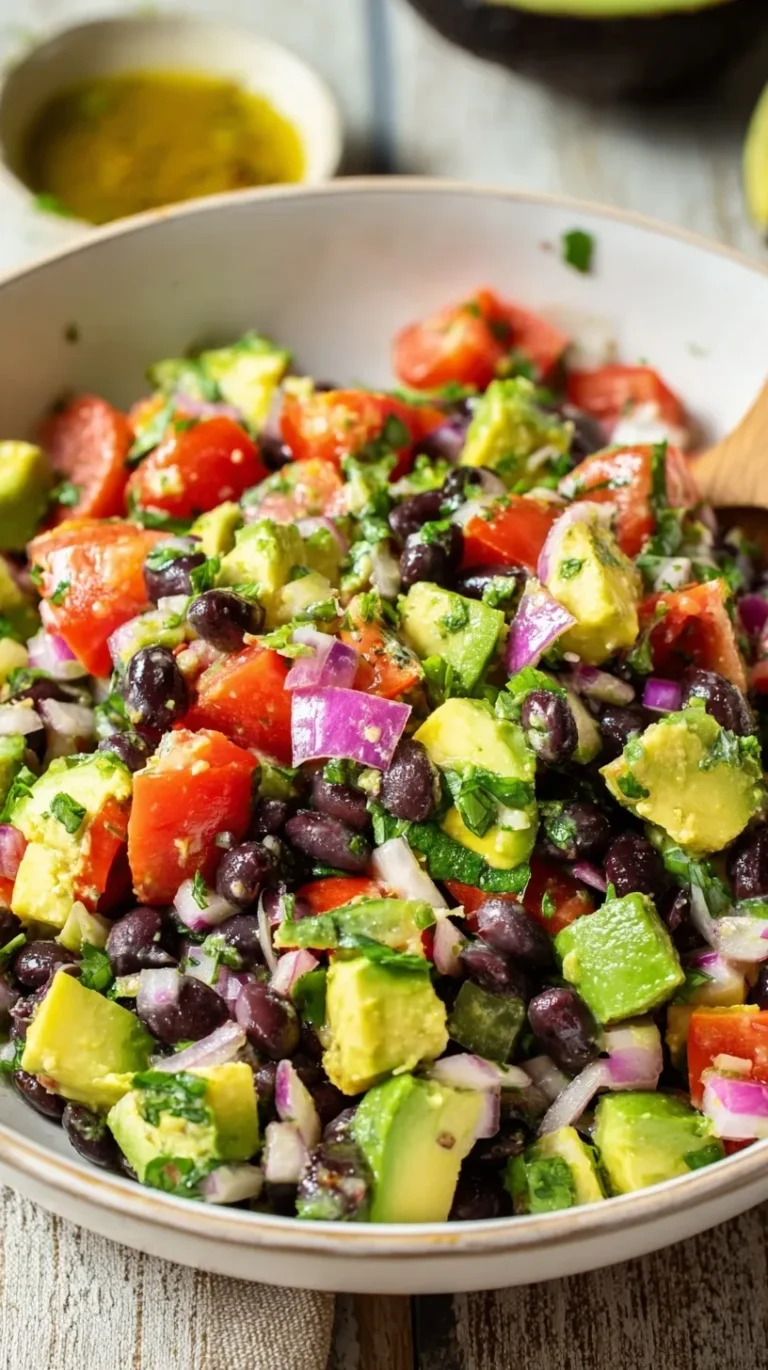 A vibrant bowl of Avocado Black Bean Salad with corn, tomatoes, and lime dressing.