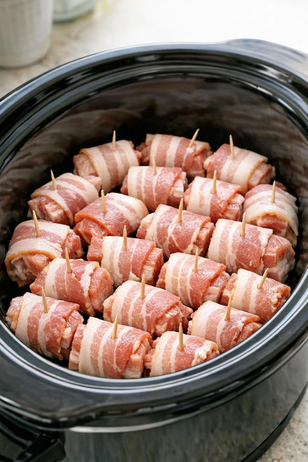 Bacon-wrapped pork belly bites in the slow cooker