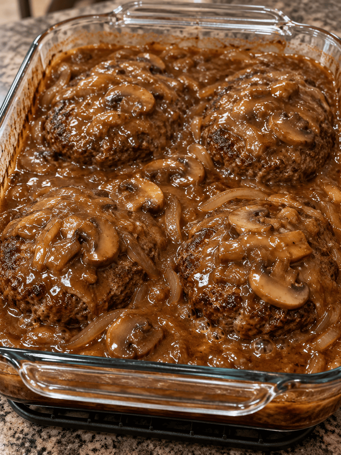 Fully cooked hamburger steaks in bubbling onion mushroom gravy