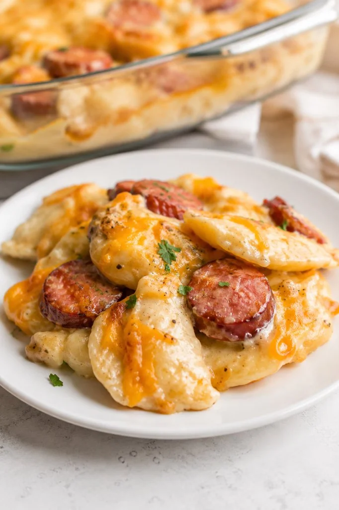 Baked pierogi casserole with kielbasa served in a dish