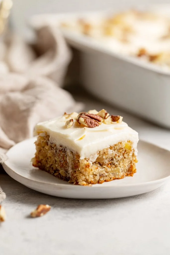 Slice of Banana Pineapple Cake with Cream Cheese Frosting on a plate