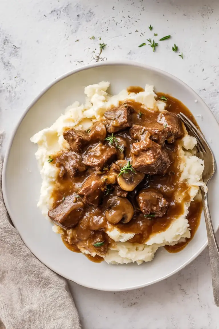 Slow cooker mushroom beef tips with gravy and mashed potatoes