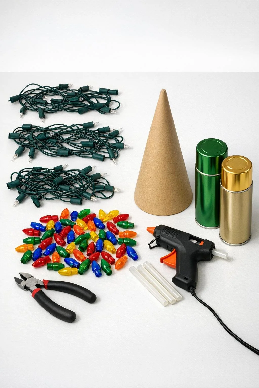 Old Christmas light strands, colorful bulb covers, cardboard cone, paint, cutters, and hot glue gun