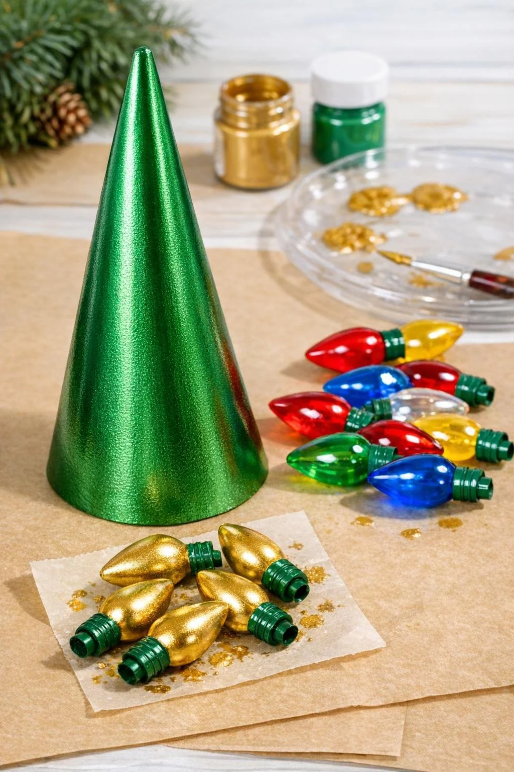 Metallic green painted cardboard cone with colorful and gold bulb covers nearby