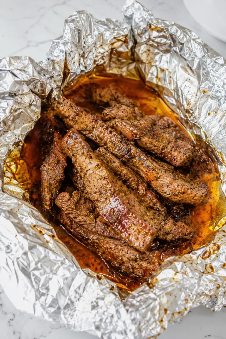 Cooked Cajun-seasoned steak resting in an open foil packet