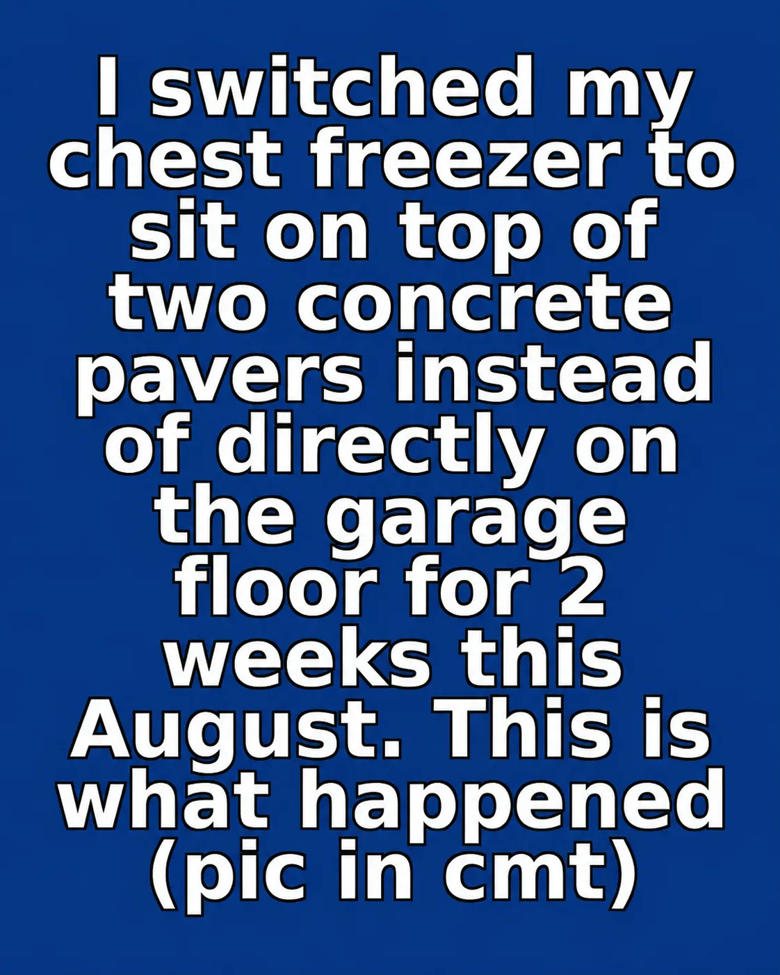 Chest freezer raised on concrete pavers on a garage floor