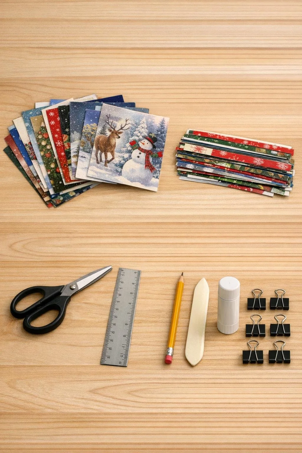 Christmas cards, narrow strips, scissors, ruler and glue on a work surface