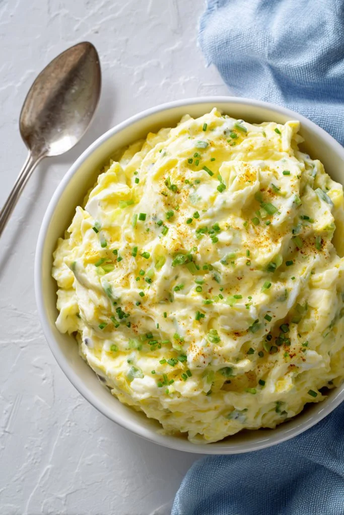 Bowl of Classic Southern Potato Salad with creamy dressing and herbs