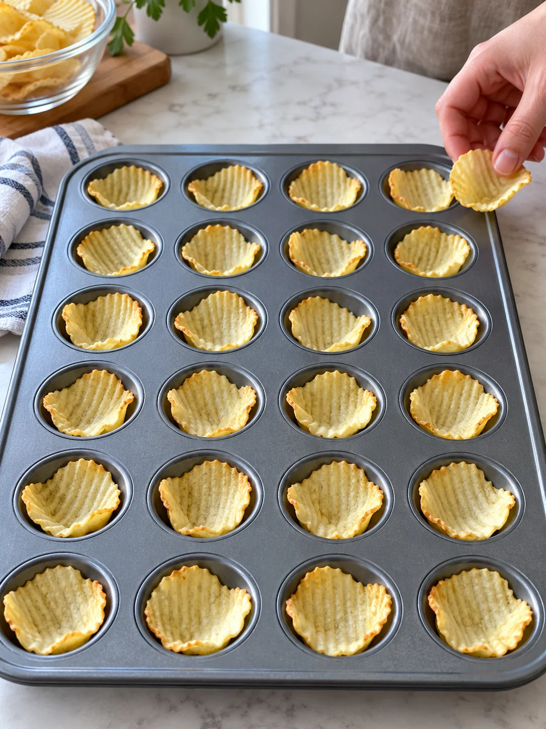 Ridged potato chips nestled into a mini muffin pan