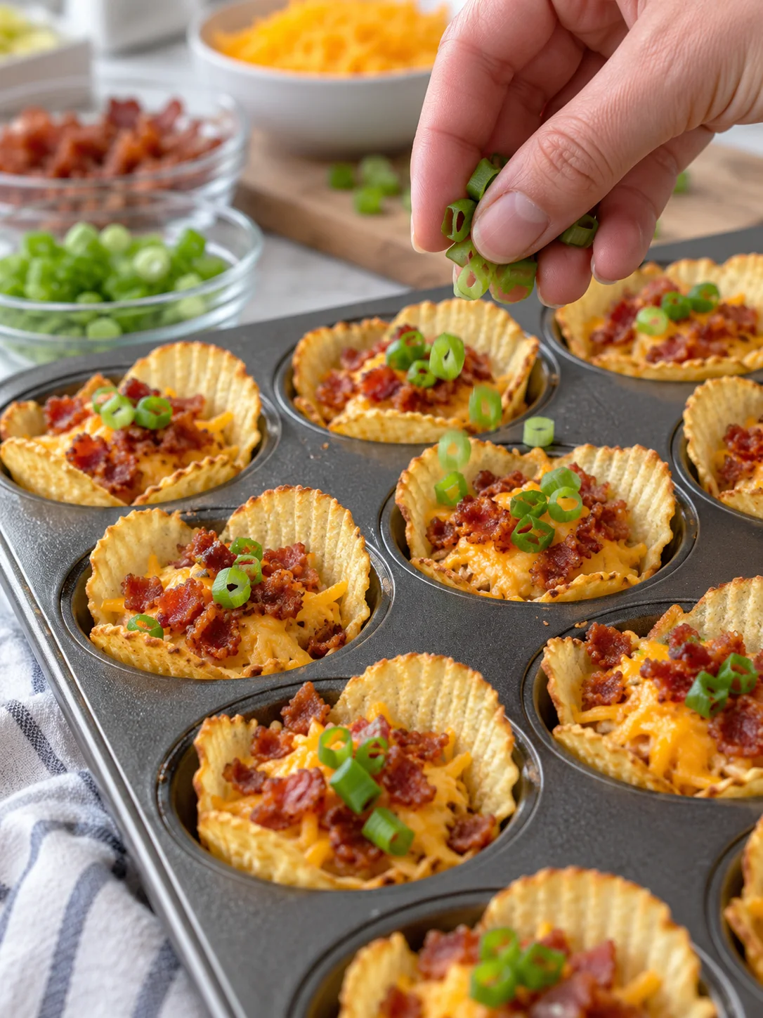Cheese cups topped with cooked bacon and green onions before baking
