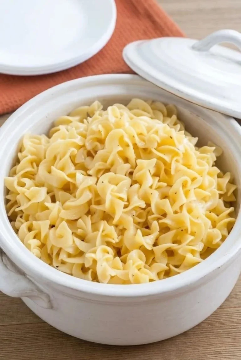 Plate of creamy crockpot butter noodles garnished with parsley