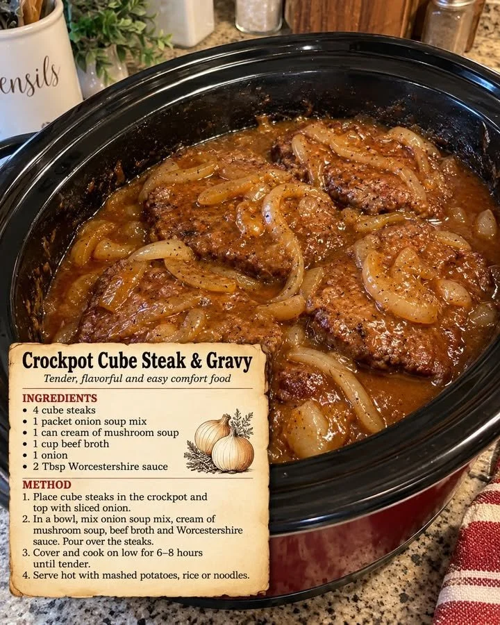 Crockpot cube steak served with rich gravy on a plate