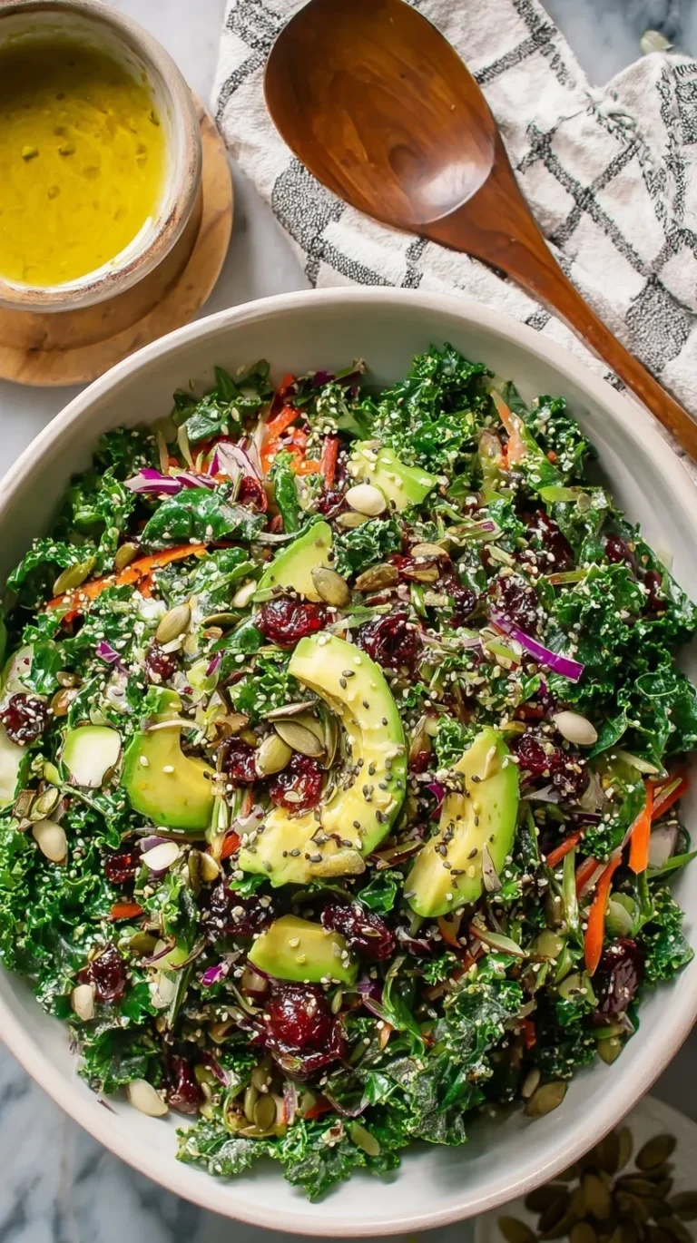 A vibrant green detox salad with kale, broccoli, and seeds in a large bowl.