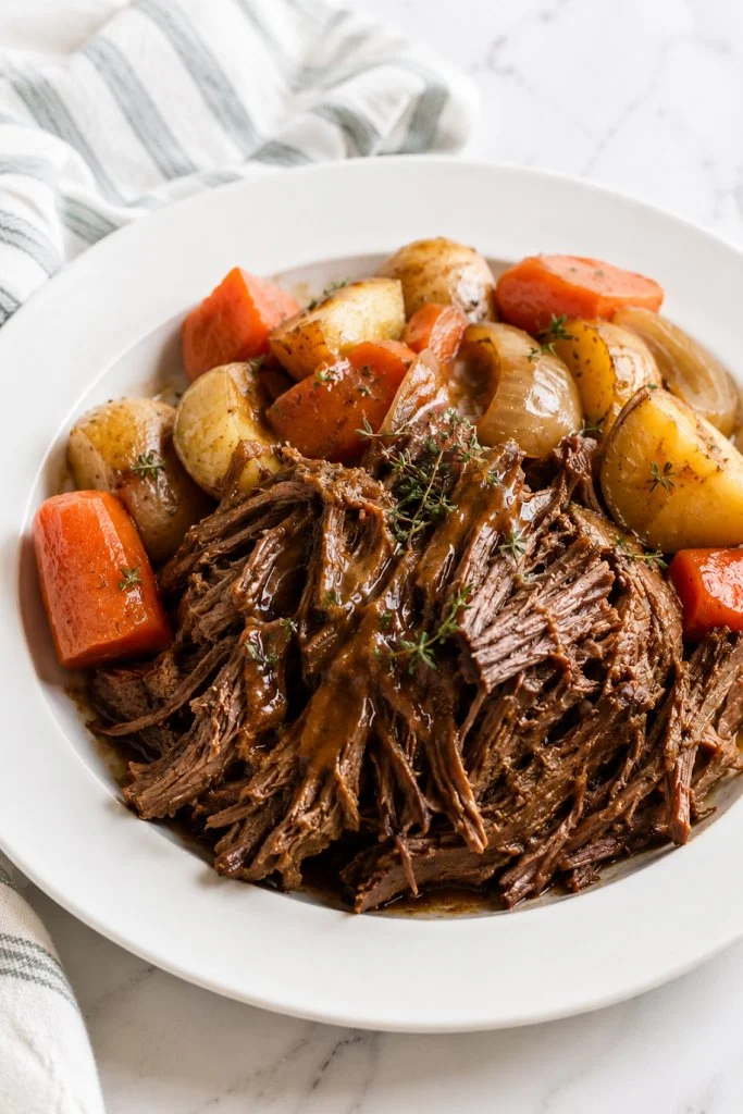 Delicious Envelope Roast served with vegetables and herbs.