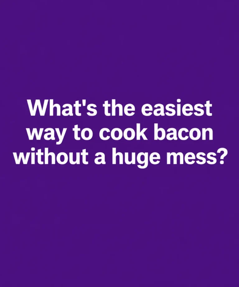 Crispy bacon strips baking on a foil-lined baking sheet in the oven