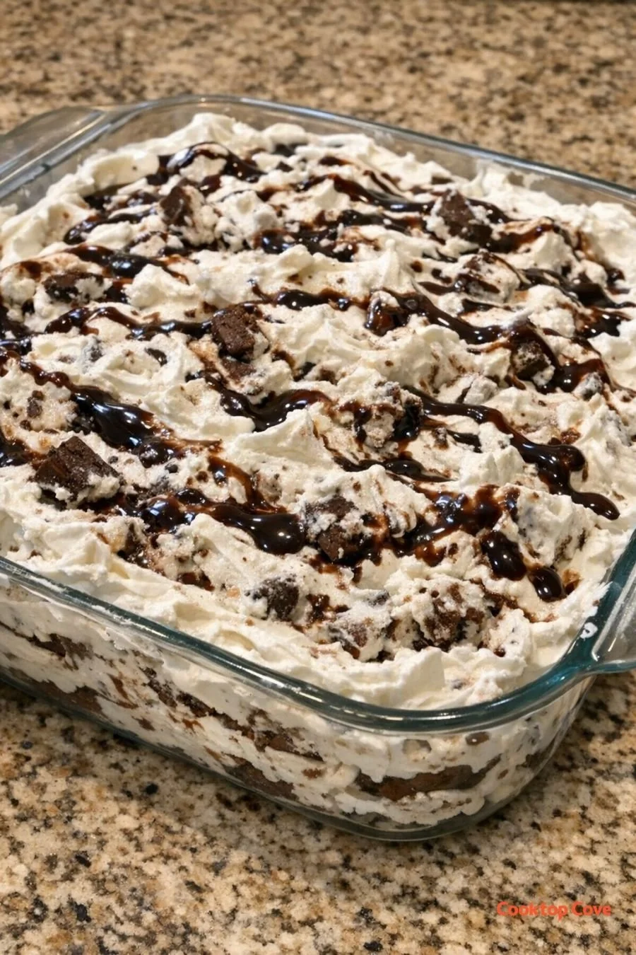 Delicious Ice Cream Sandwich Cake topped with whipped cream and cherries