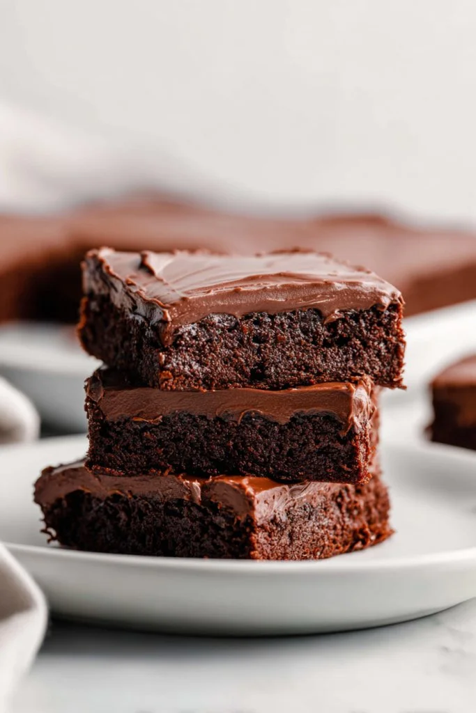 Plate of delicious Lunch Lady Brownies with chocolate frosting and sprinkles
