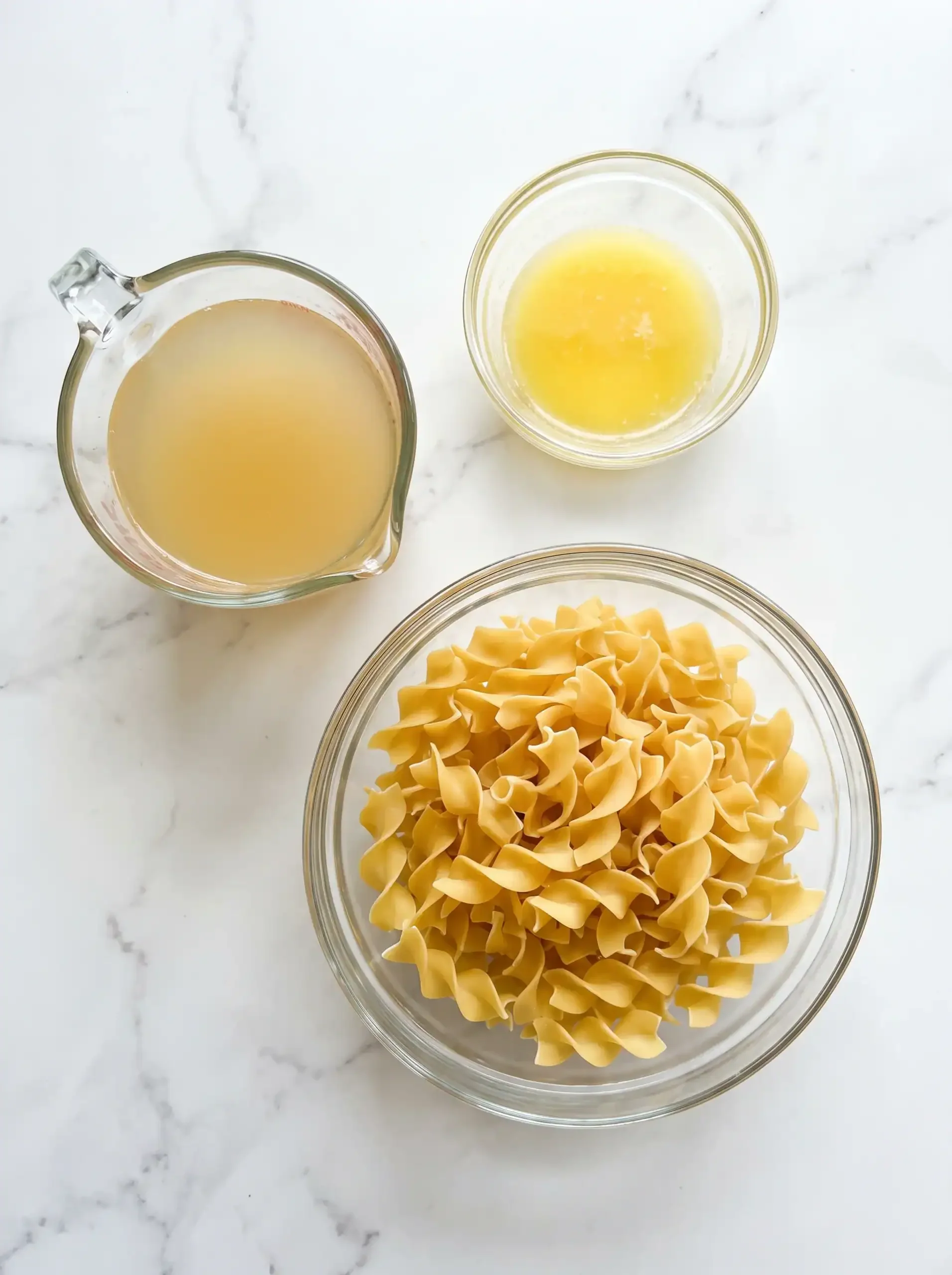 Wide egg noodles, melted butter, and chicken broth