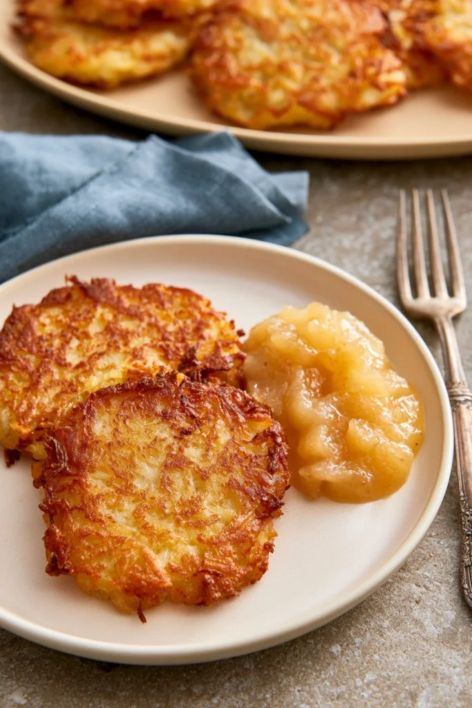 Crispy Old-Fashioned German Potato Pancakes garnished with herbs