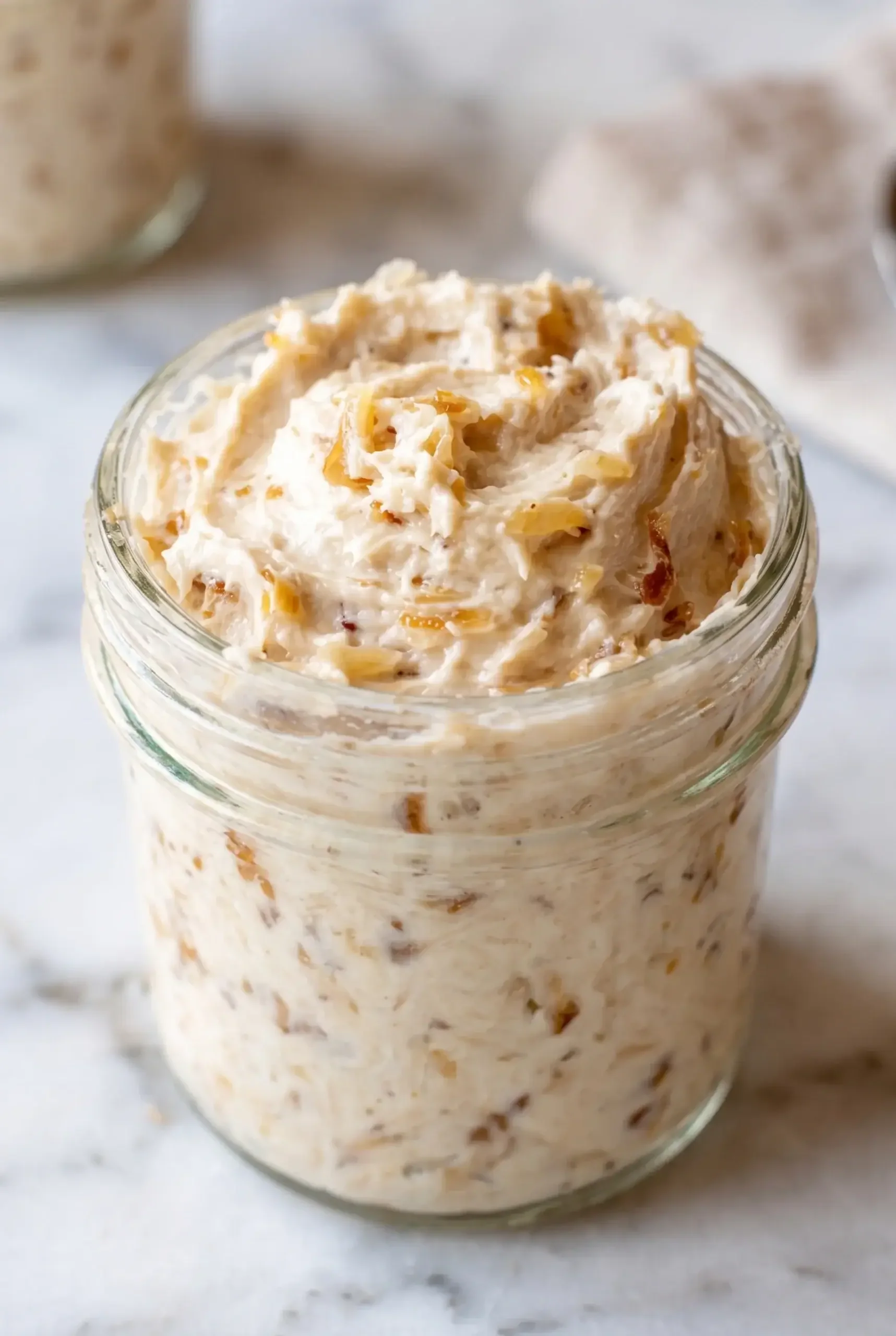 A jar of creamy French onion butter with visible onion pieces