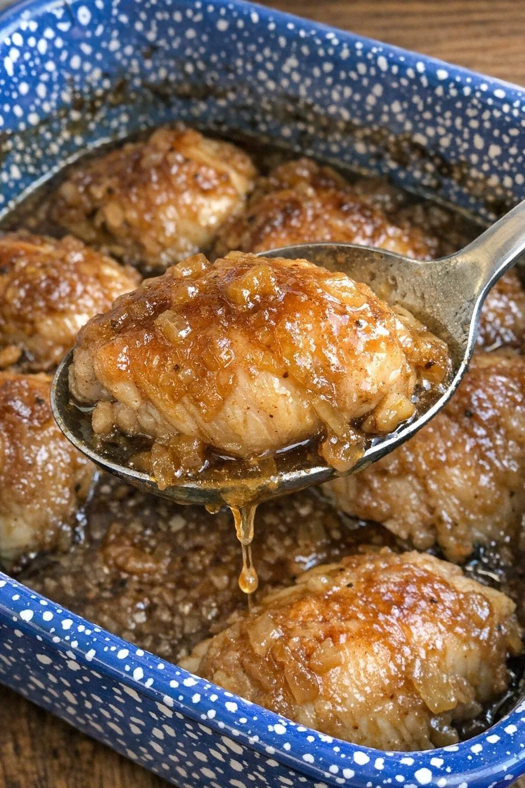 Oven baked 3-ingredient Company Chicken served on a plate with herbs.