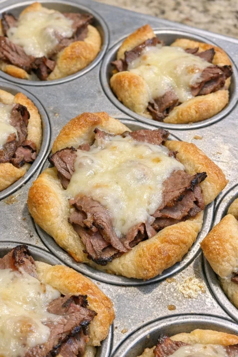 Oven baked roast beef and fontina crescent cups on a serving platter.