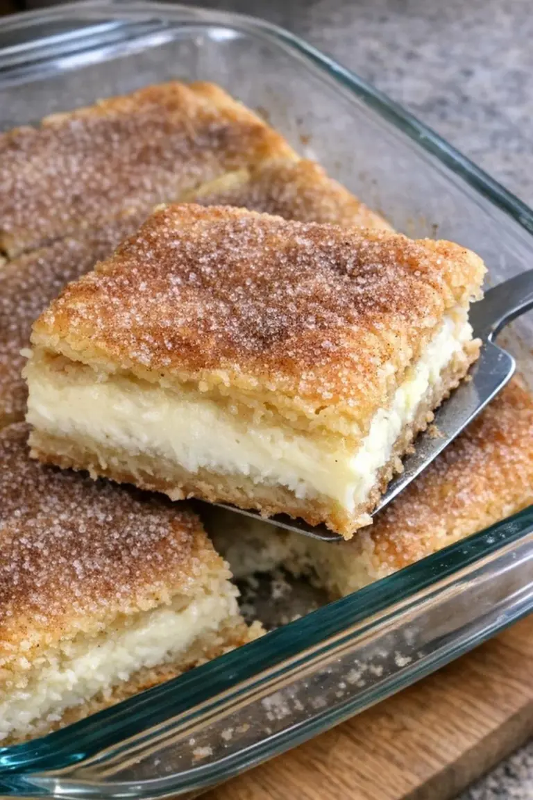 Delicious oven-baked Sopapilla Cheesecake bars topped with cinnamon sugar