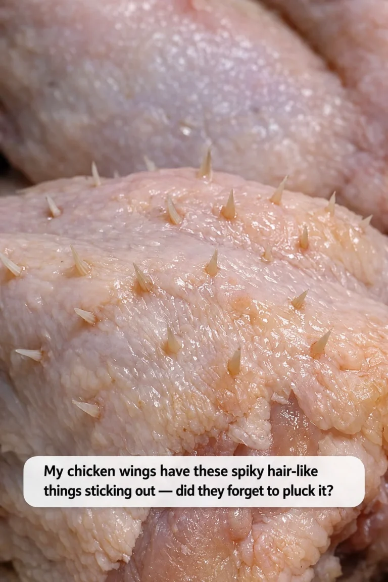 Raw chicken wings with small pin feathers visible on the skin