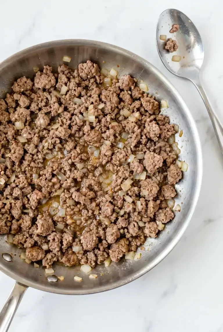 Ground beef browned and crumbled in a skillet