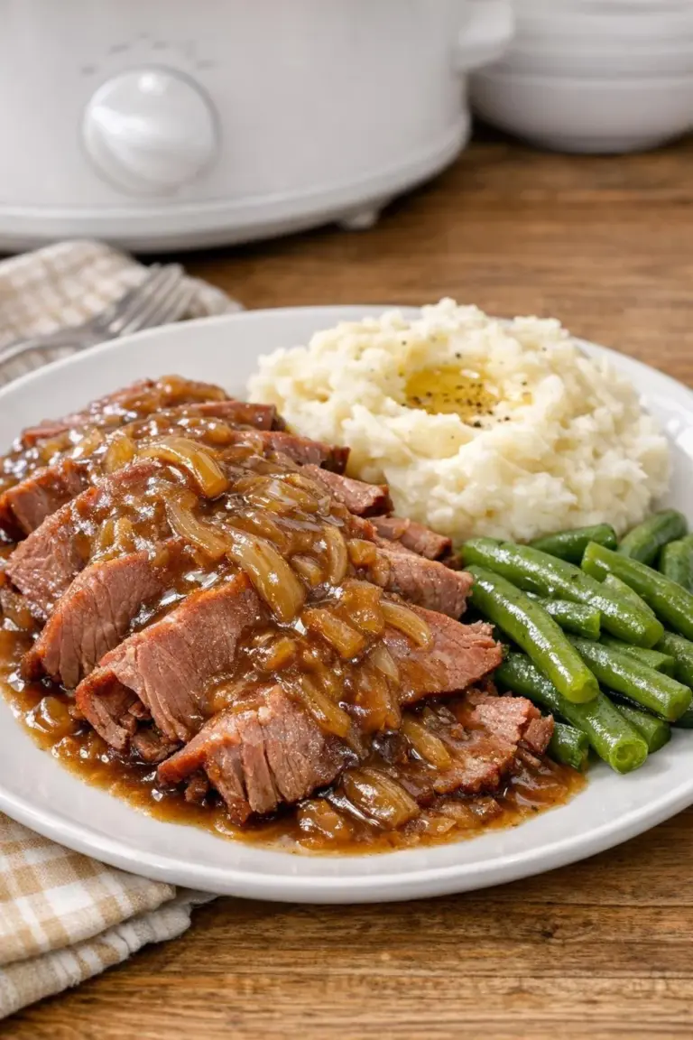 Slow Cooker French Onion Corned Beef with onions and spices in a dish