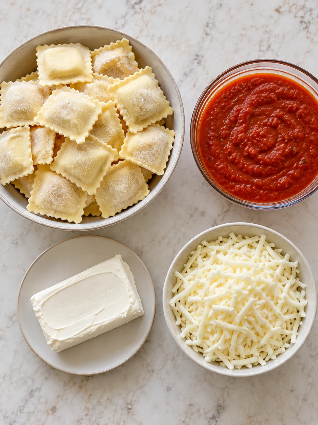 Four ingredients for creamy ravioli: frozen cheese ravioli marinara cream cheese and mozzarella