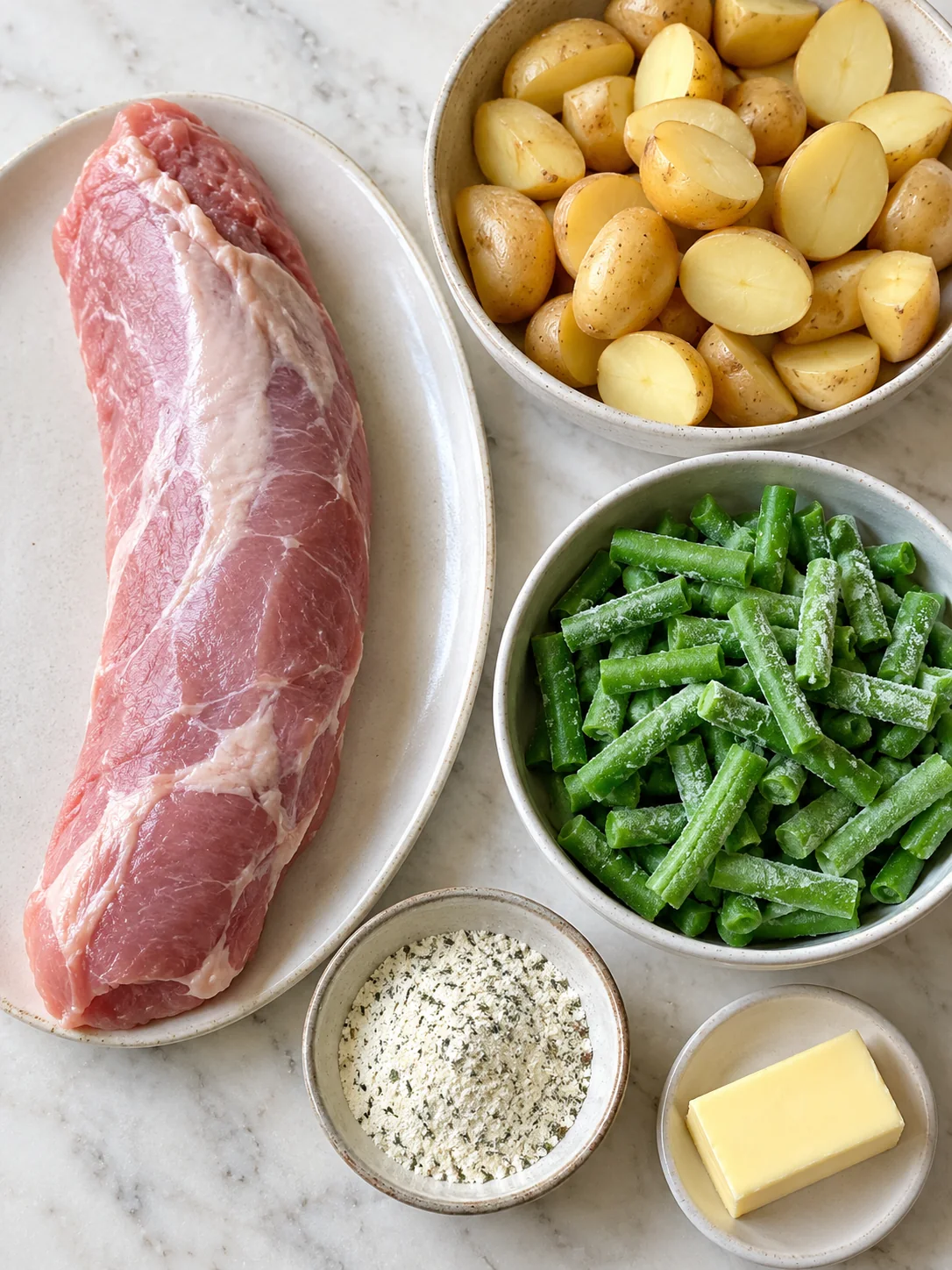 Five ingredients for ranch pork tenderloin: pork, potatoes, green beans, ranch seasoning and butter